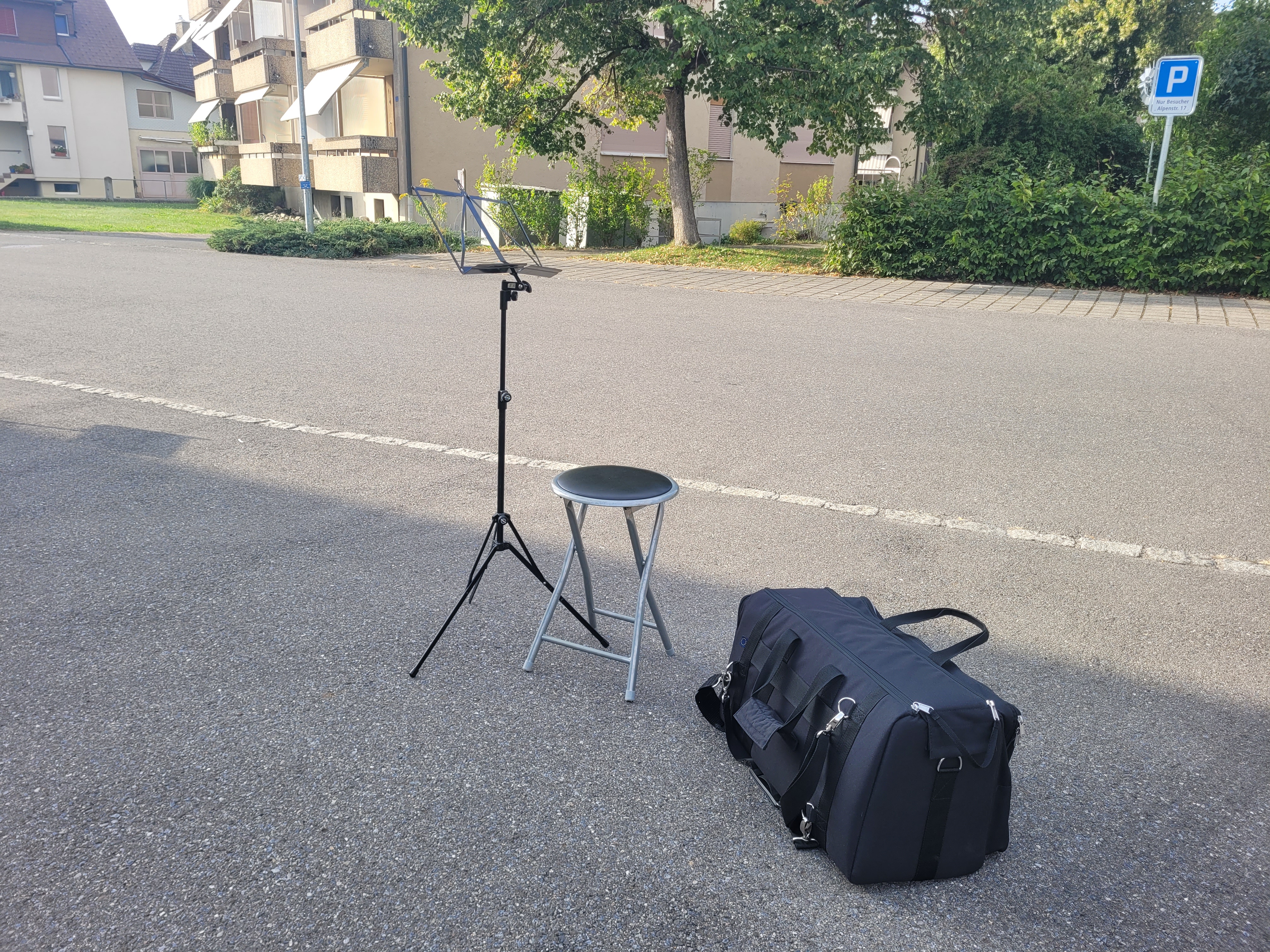 Symbolisches Bild mit einzelnem Notenständer Stuhl und Instrumentenkoffer